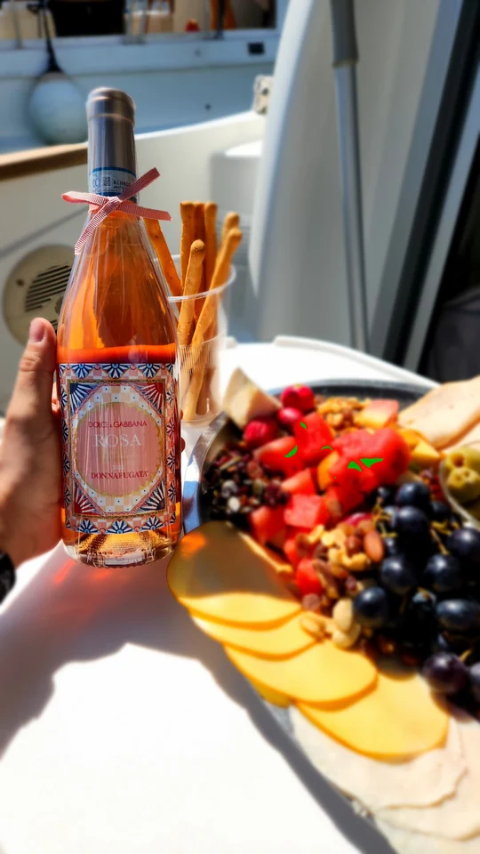 Fruit, snacks and a bottle arranged on board.